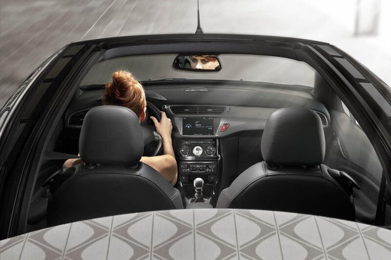 Woman driving convertible car
