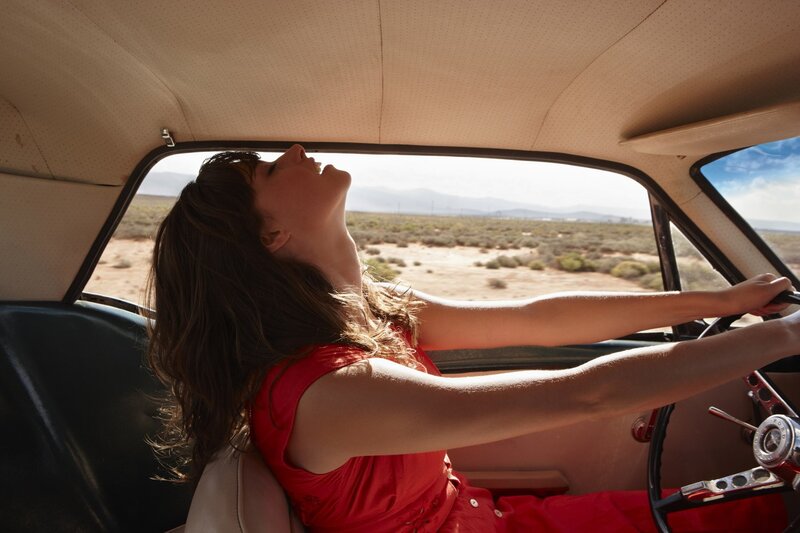 Woman driving in desert car
