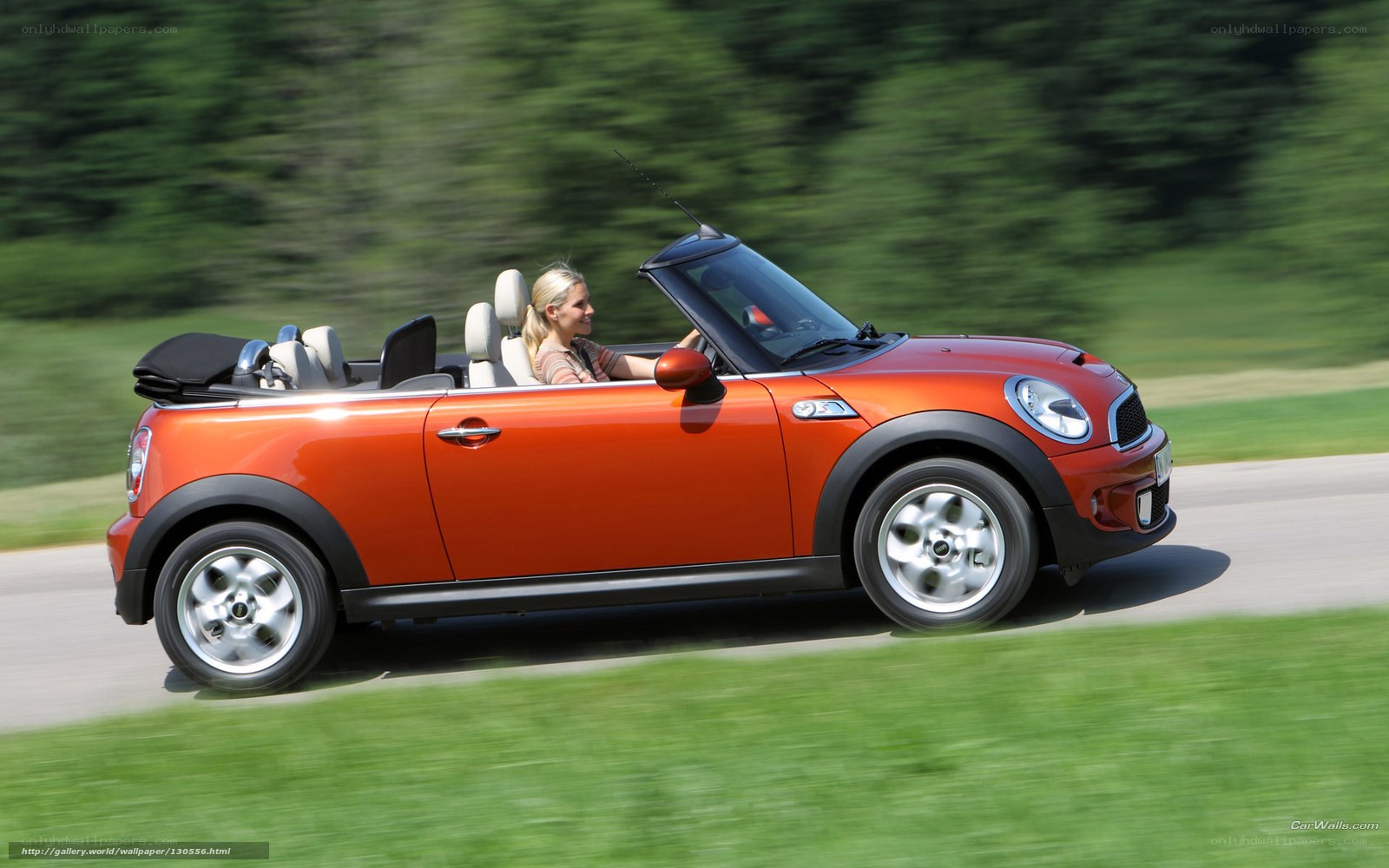Woman driving orange convertible