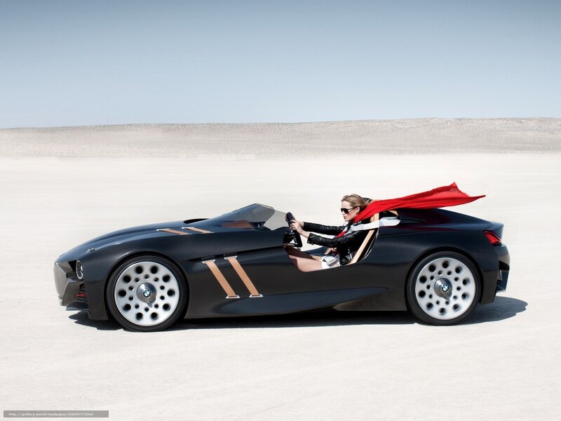 woman driving sports car in desert