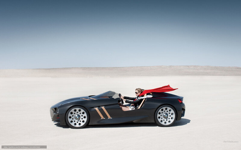 woman driving sports car in desert