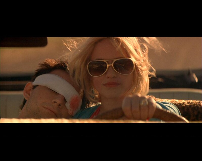 woman driving with blindfolded man