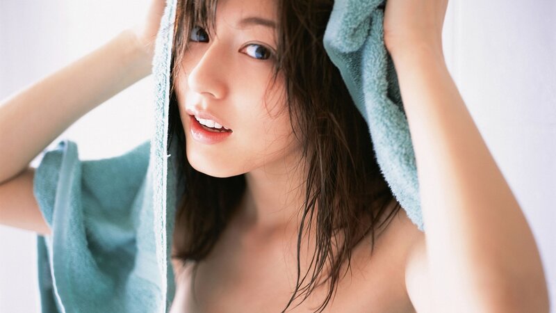 woman drying hair with towel