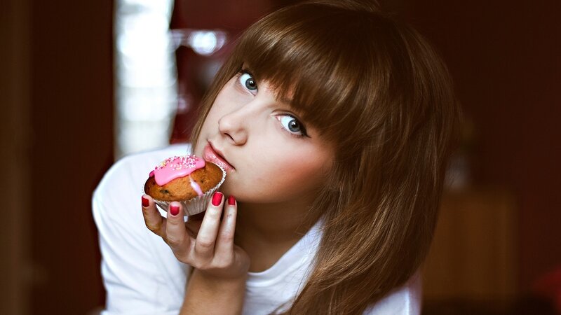 woman eating a cupcake