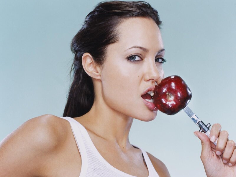 woman eating a red apple