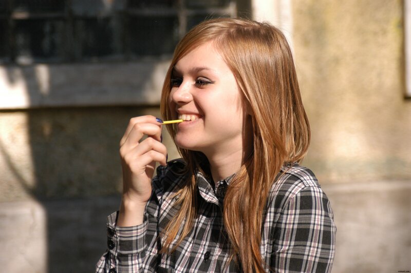 woman eating a snack outdoors
