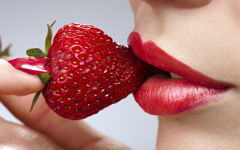 woman eating a strawberry