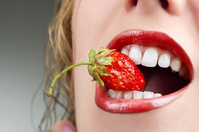 woman eating a strawberry