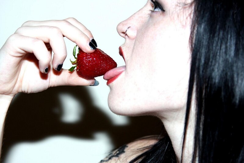 woman eating a strawberry