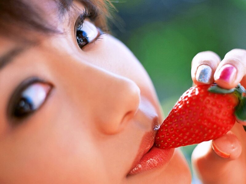 woman eating a strawberry