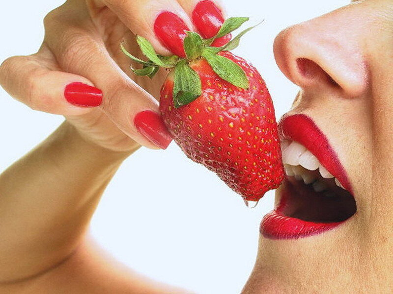 woman eating a strawberry