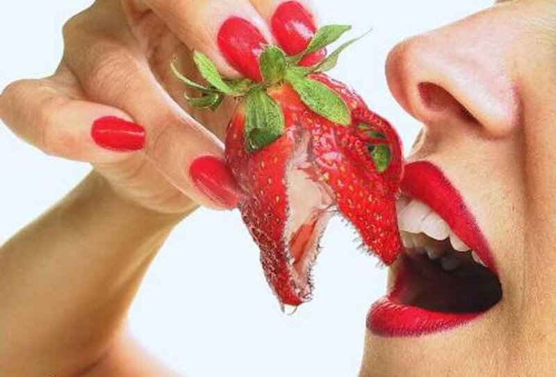 woman eating a strawberry