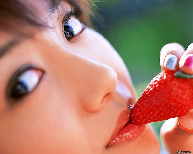 woman eating a strawberry