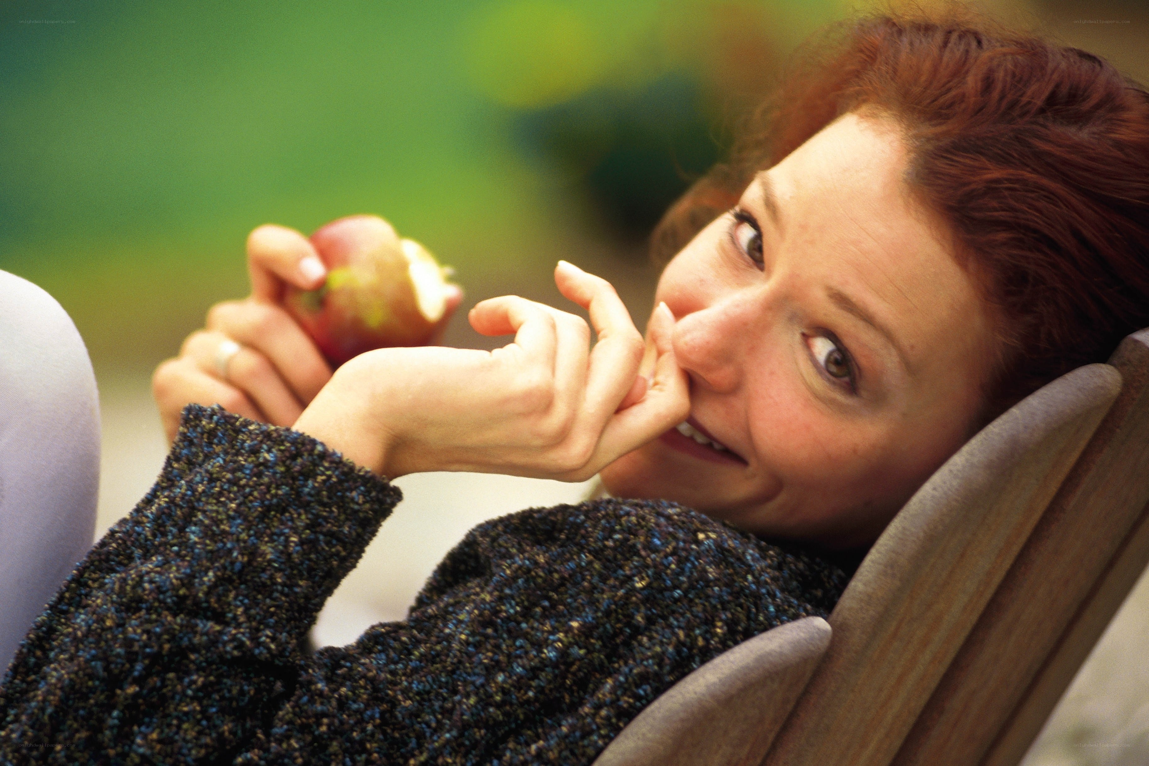 woman eating apple outdoors