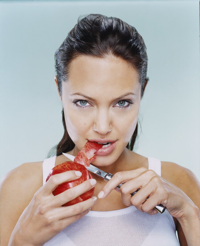 woman eating apple with knife