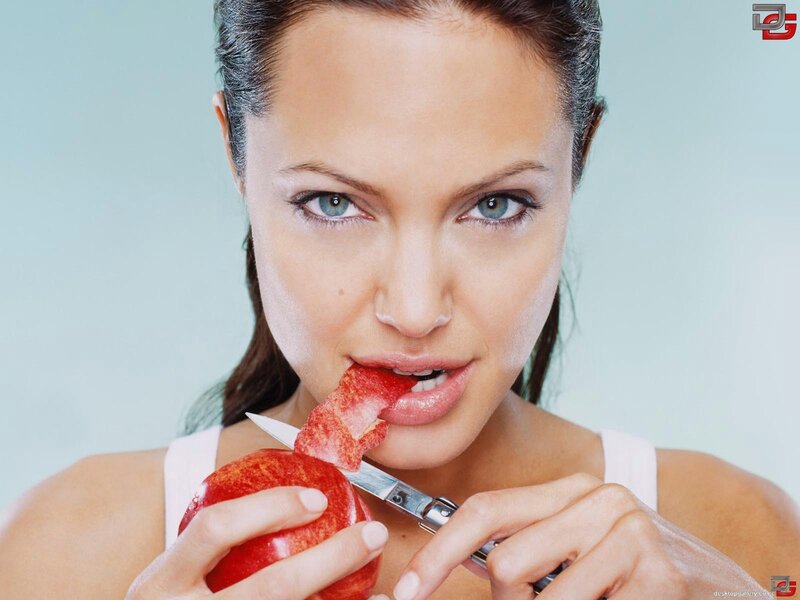 woman eating apple with knife