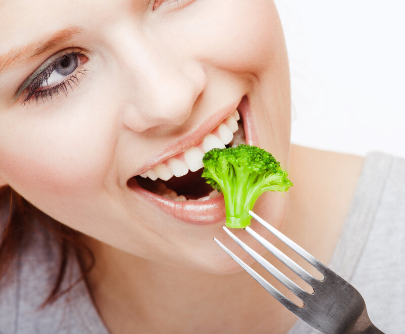 Woman Eating Broccoli