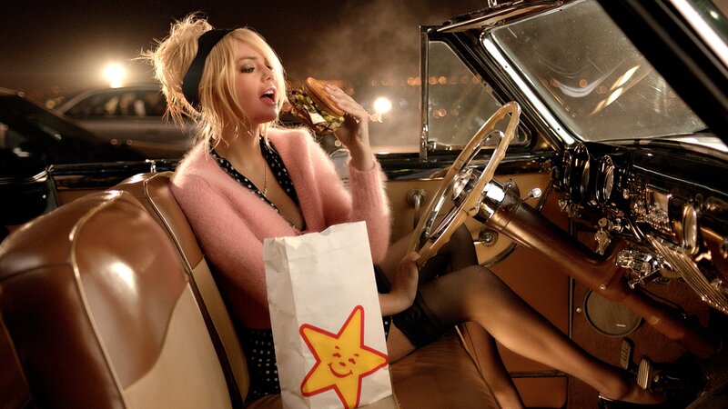 Woman Eating Burger in Car — Brown