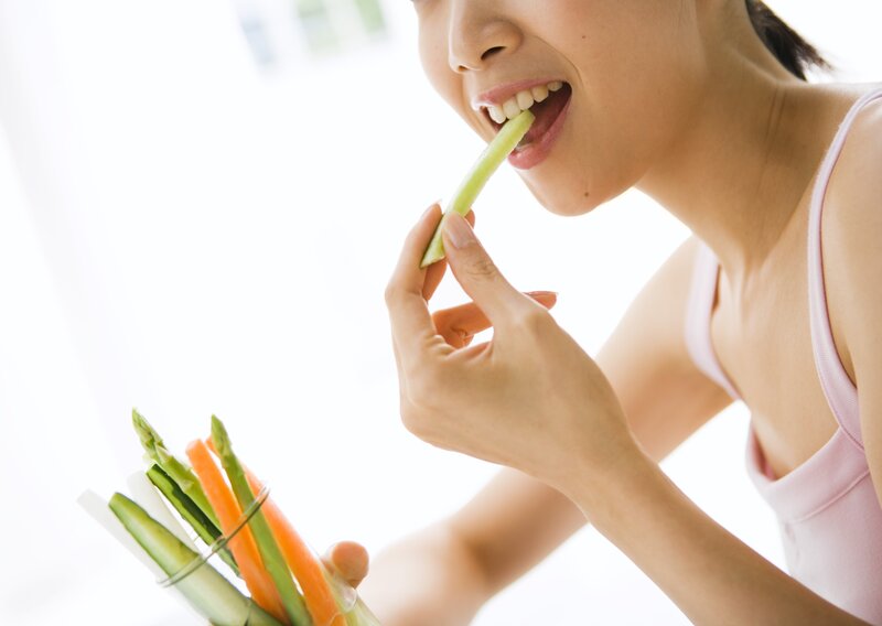 woman eating celery stick