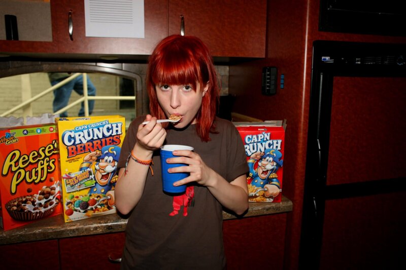woman eating cereal in kitchen