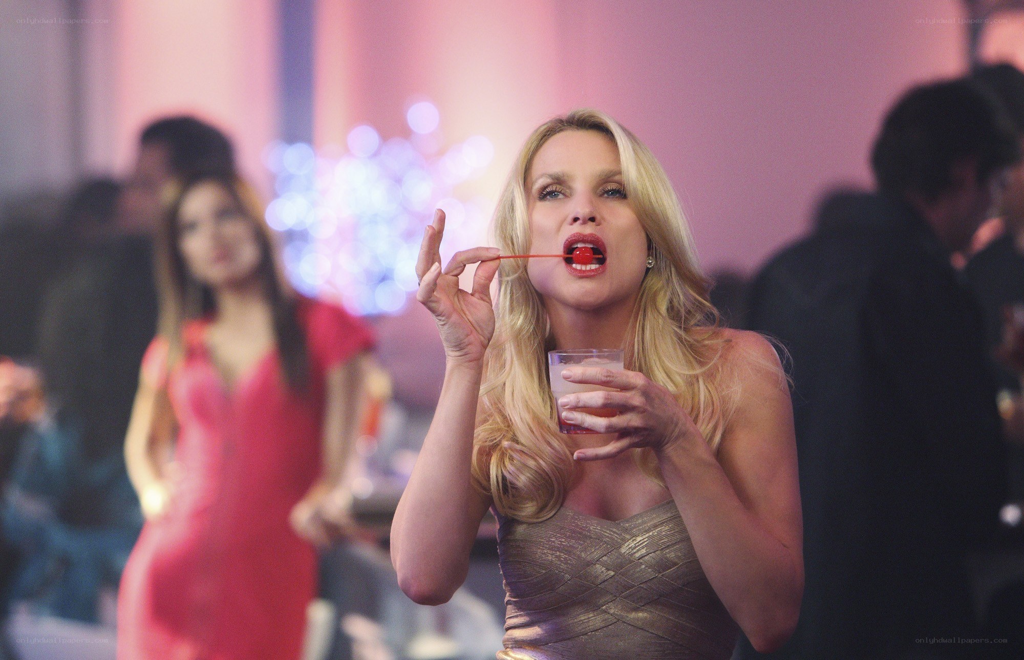 woman eating cherry at party