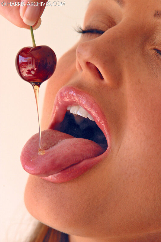 woman eating cherry with honey