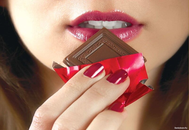 woman eating chocolate bar