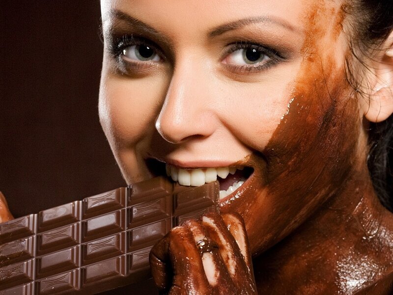woman eating chocolate bar