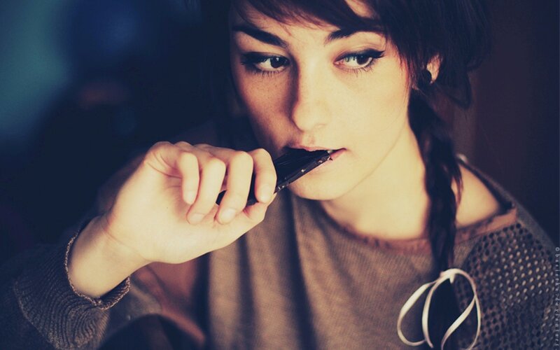 woman eating chocolate bar