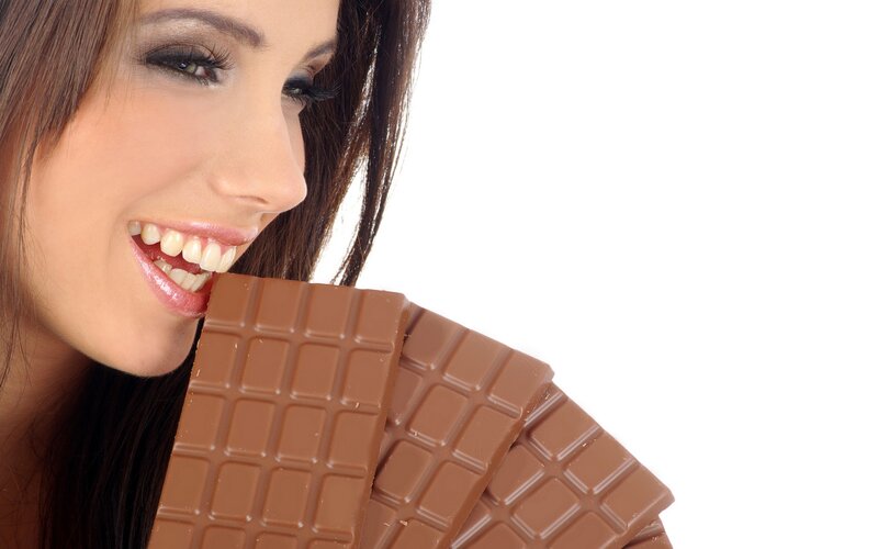 woman eating chocolate bar