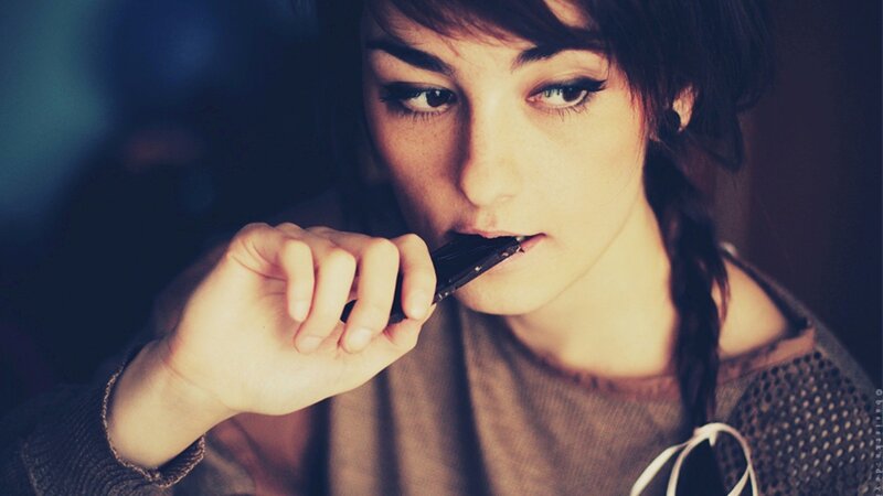 woman eating chocolate bar