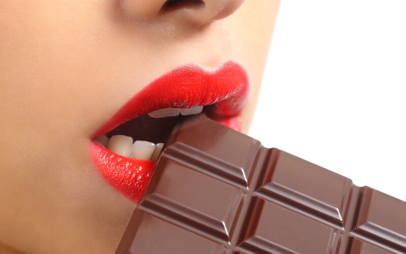 Woman Eating Chocolate Bar — Red