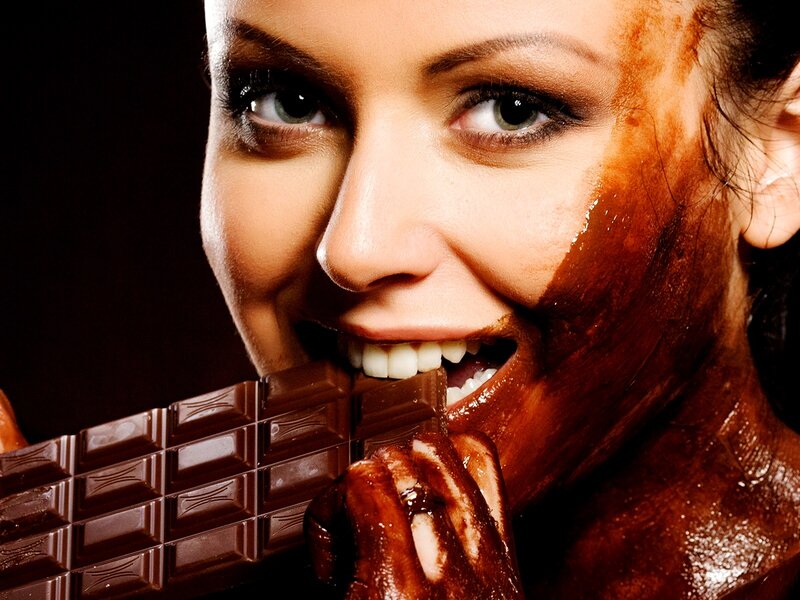 Woman Eating Chocolate — Brown, Dramatic