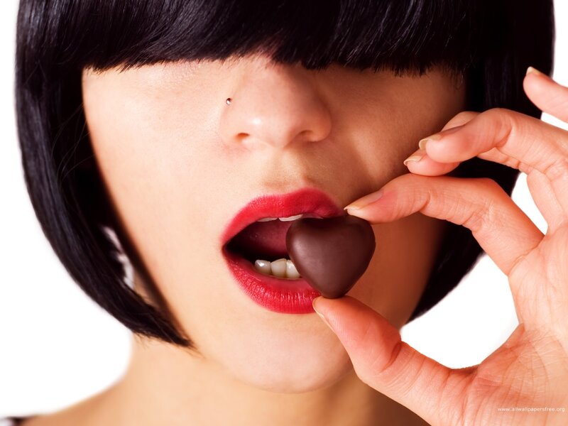 woman eating chocolate heart