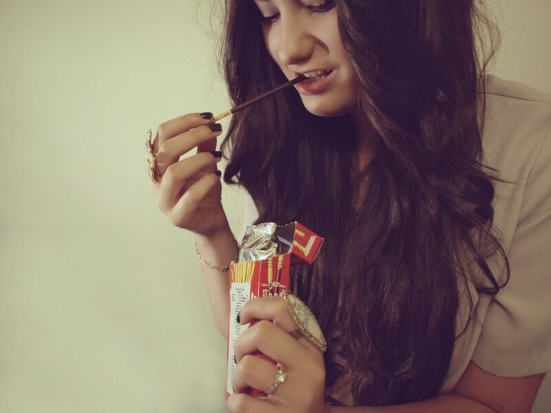 woman eating chocolate stick
