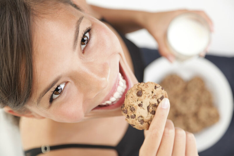 Woman Eating Cookie — Brown