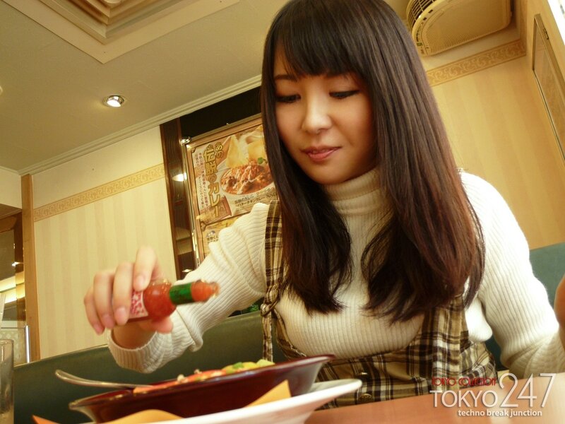 woman eating curry in restaurant