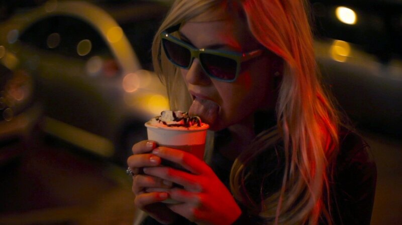 woman eating dessert at night