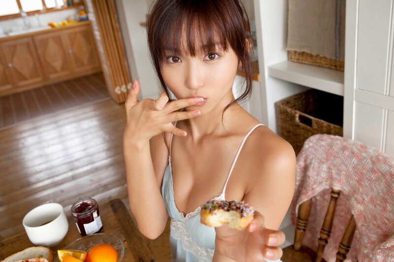 woman eating donut in kitchen