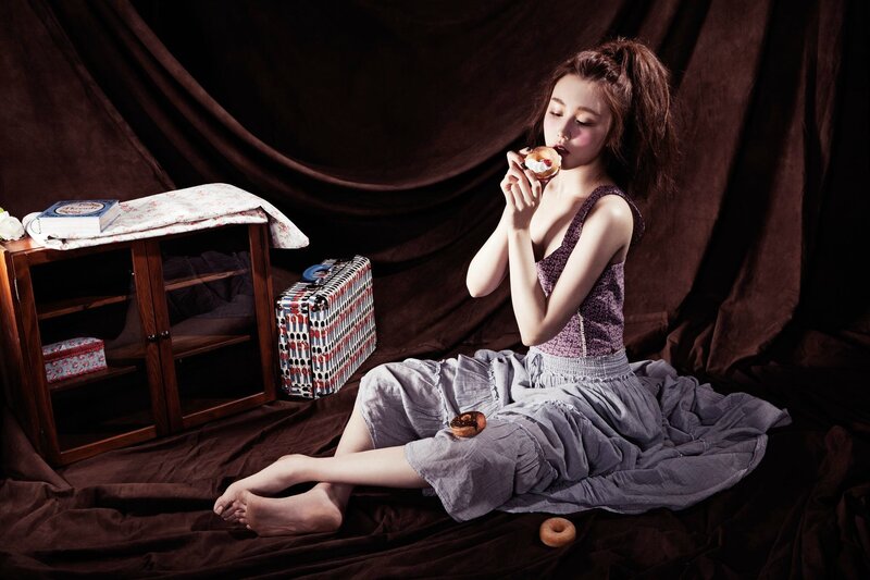 woman eating donut on floor
