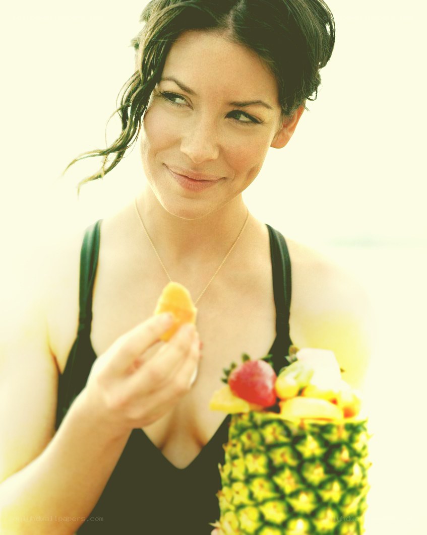 woman eating fruit from pineapple