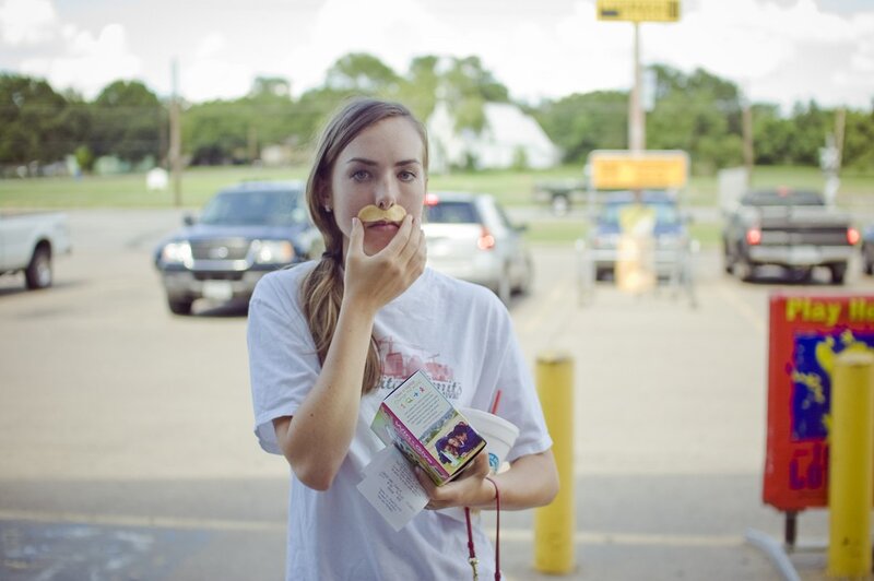 woman eating in parking lot