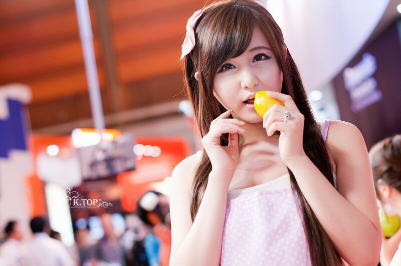 woman eating lemon at event
