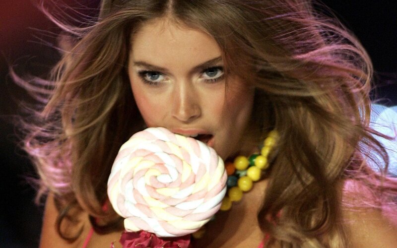 Woman Eating Lollipop — Brown, Dramatic, Photograph