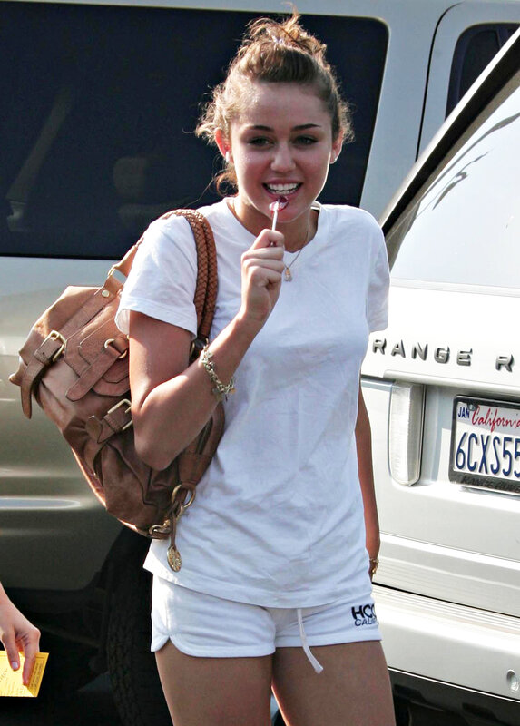 woman eating lollipop outdoors