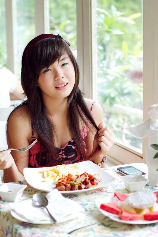 Woman eating meal at table