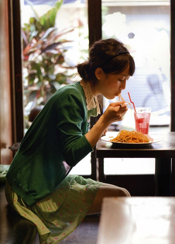 woman eating pasta at a cafe