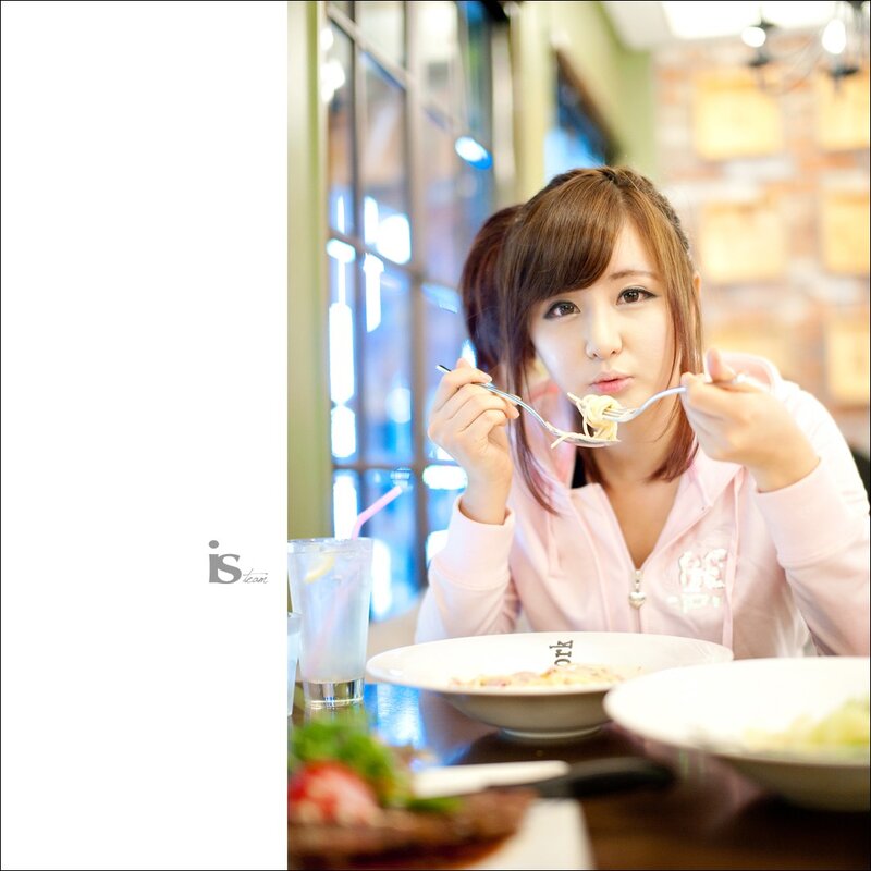woman eating pasta at restaurant