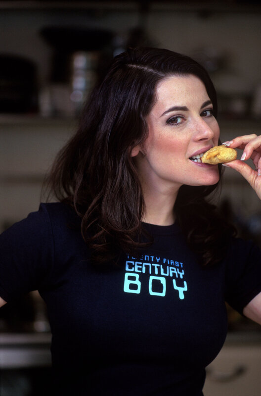 woman eating pastry in kitchen