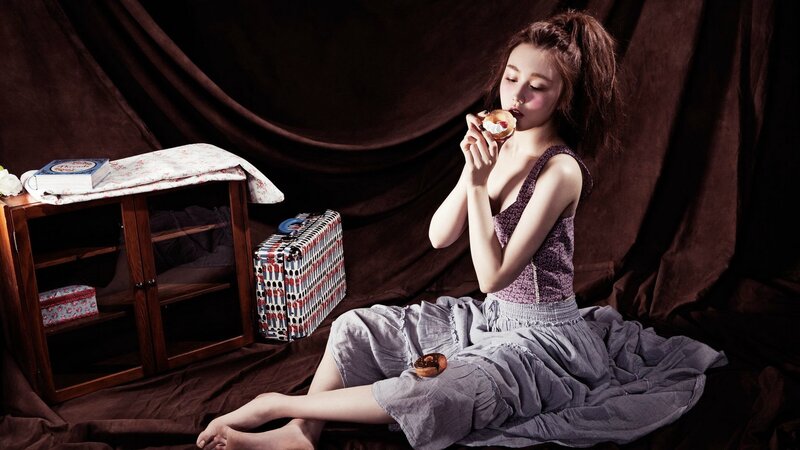 woman eating pastry in studio